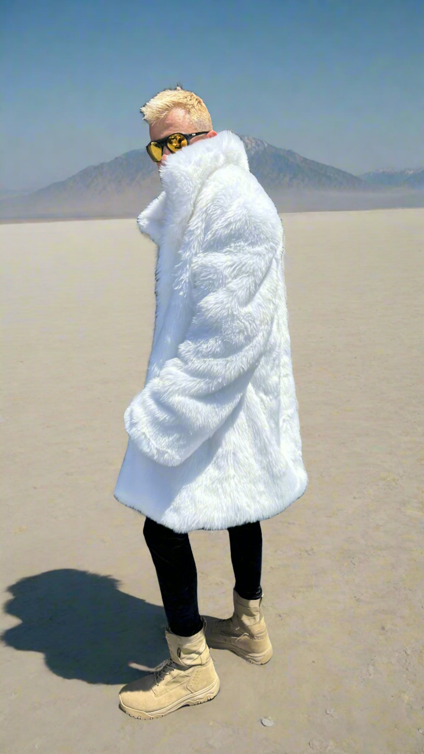 Man wearing Polar Wolf Fur Coat with white faux fur exterior, standing confidently with open coat showcasing bare chest and black pants.